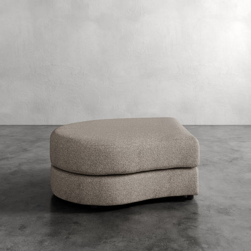 Lemieux Et Cie Rulmann Left Ottoman Gray ottoman on a concrete floor with a plain wall background