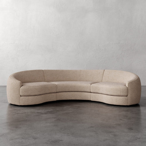 Lemieux Et Cie Rulmann Rulmann 3-Piece Sectional Beige curved sofa on a gray floor with a plain gray wall background