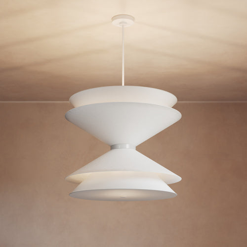Lemieux et Cie Balleroy Chandelier in white with tiered sculptural shades, pendant lighting suspended against warm neutral ceiling and walls.