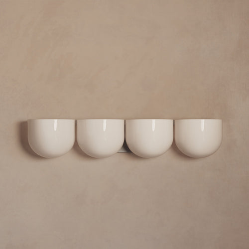 Lemieux et Cie Cocoon Lamp in white resin and metal, four rounded diffusers mounted on neutral plaster wall in soft light