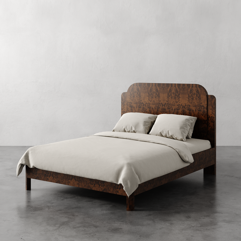 Lemieux et Cie Avenir Bed with figured headboard and frame, bed shown dressed in neutral linens on concrete floor against plaster walls.