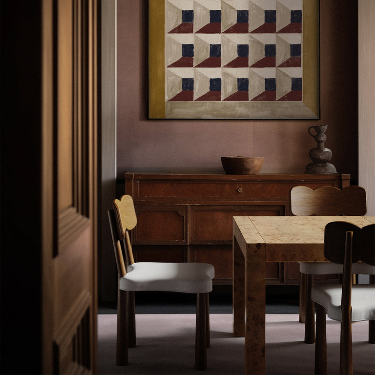 Lemieux et Cie Avenir Dresser in Mappa Burl with hand-cast brass hardware, styled in a dining room with geometric framed artwork and warm plaster walls.