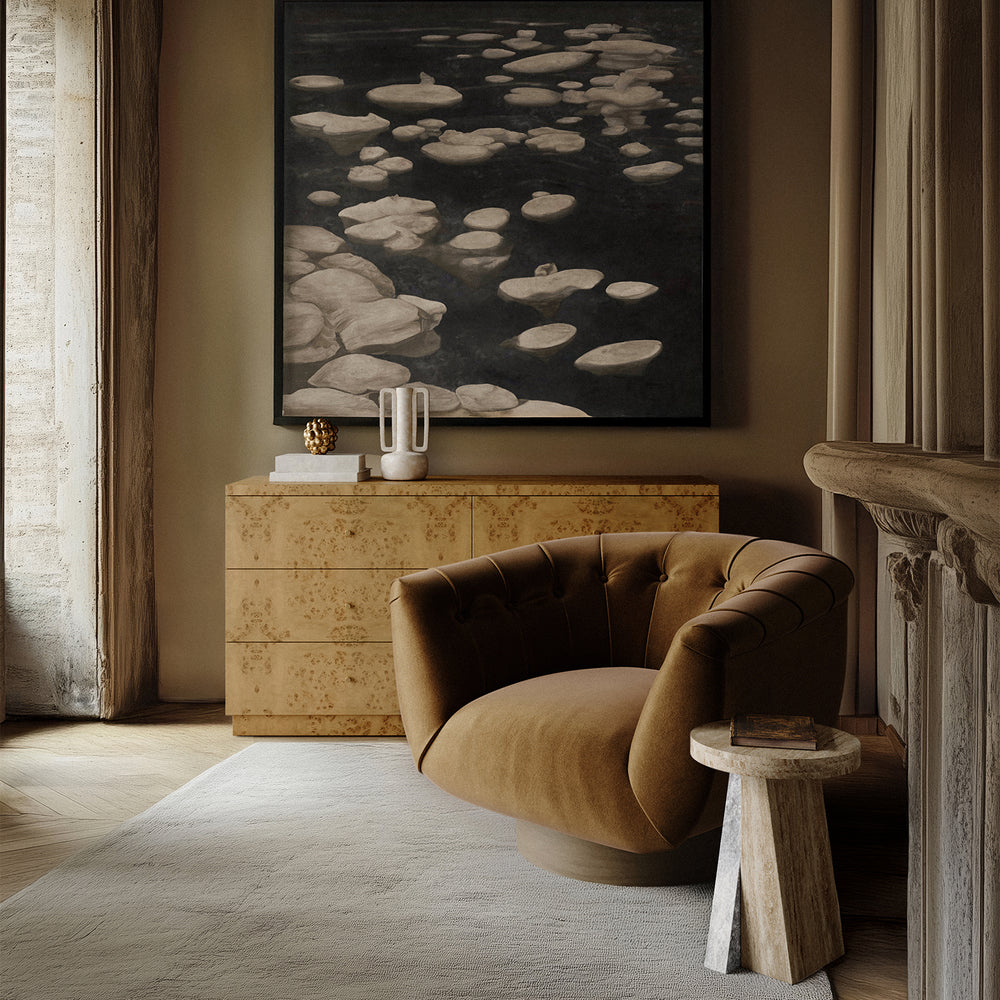 Lemieux et Cie Borel Side Table in walnut, sculptural accent piece beside a tufted chair in a sitting room with neutral plaster walls and wood flooring.