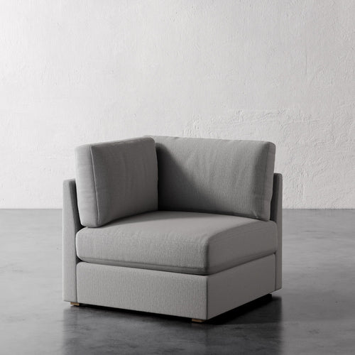 Lemieux Et Cie Chanaux Corner Chair Gray corner sofa against a white wall