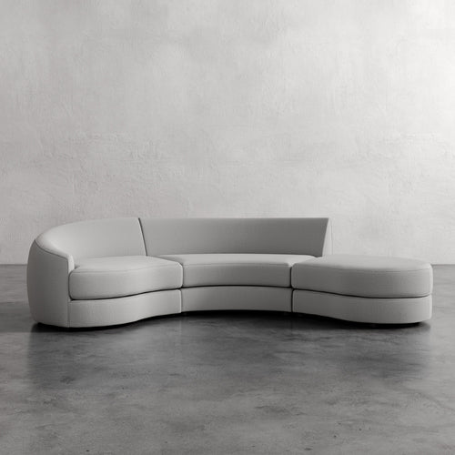Modern gray sectional sofa against a plain wall. Rulmann 3-Piece Left Sectional Basket Silver