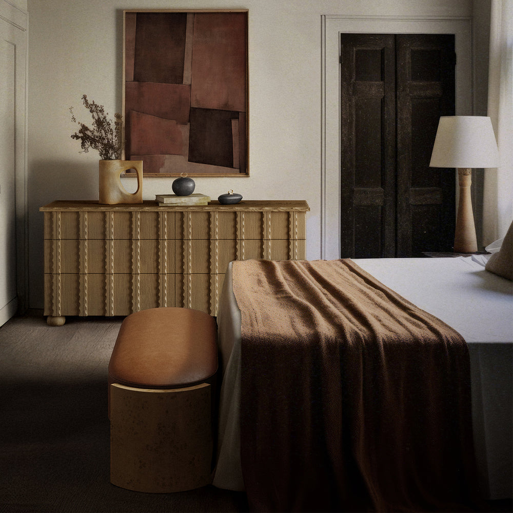 Lemieux et Cie Marchand 6-Drawer Dresser with scalloped edge detailing and turned legs, styled in a bedroom with neutral walls and warm light.