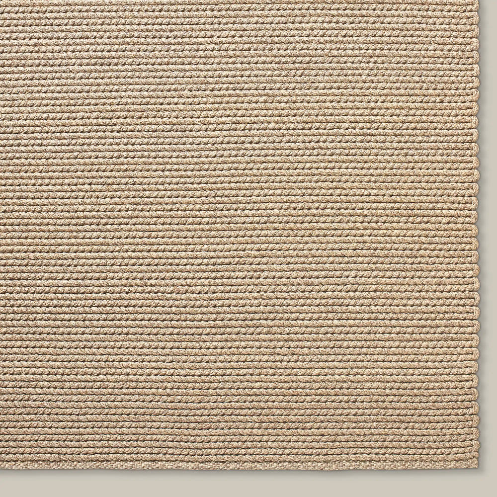 Lemieux et Cie Tricot Handwoven Outdoor Rug in natural tones, textured horizontal weave pattern shown on neutral studio backdrop.