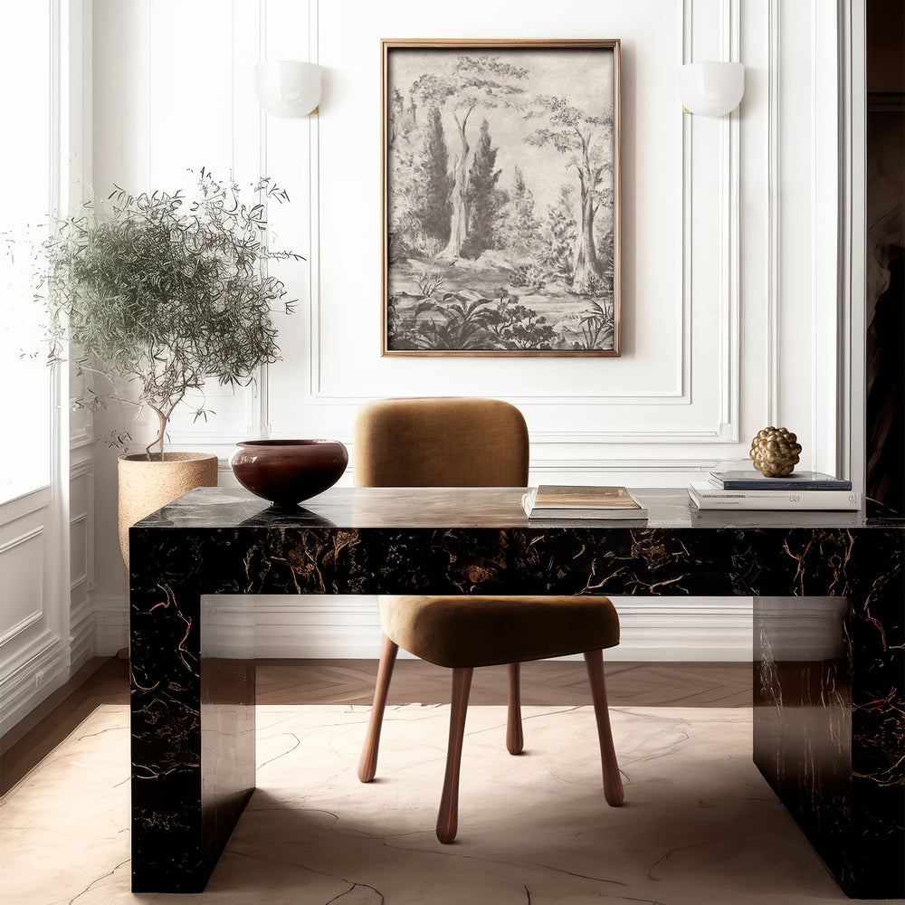 Lemieux et Cie Bois de Boulogne print in grisaille tones, framed panoramic art above a dark marble desk with tan upholstered stool in white-paneled room.