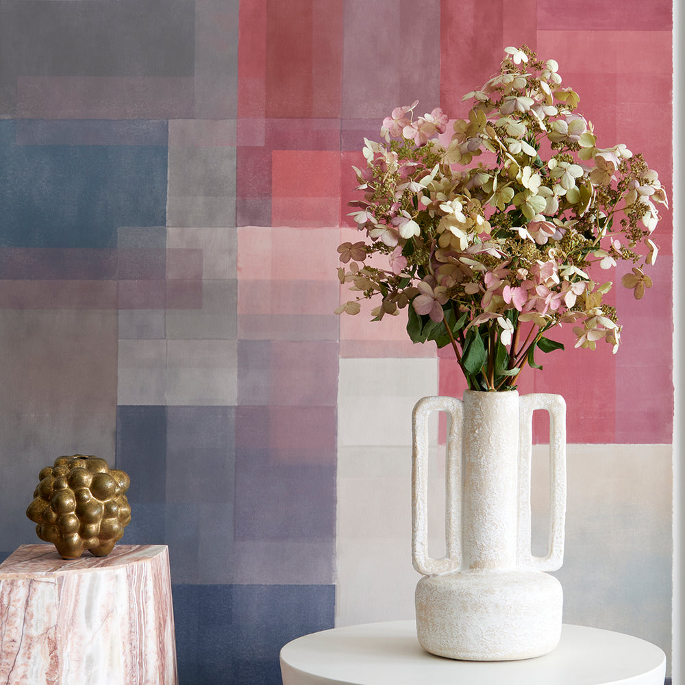 Lemieux et Cie Bretagne Vase in light grey with geometric square handles, ceramic vase styled against multicolored plaid wall with dried hydrangea stems.