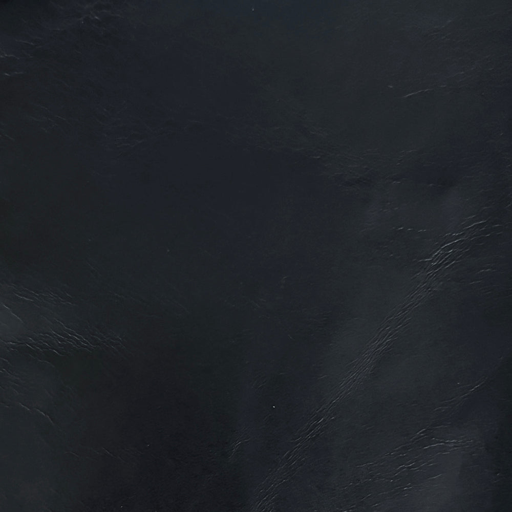 Lemieux et Cie Aniline Leather Swatches, dark textured leather material sample with visible grain detail shown against dark surface.