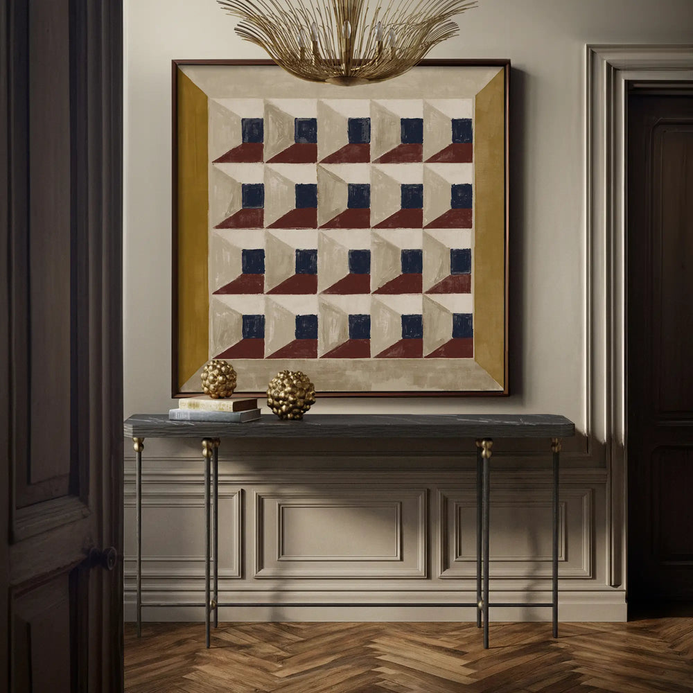 Lemieux et Cie Cambert Console in honed Nero Marquina marble with hammered iron frame, entry table styled with sculptural objects beneath geometric framed art and neutral paneled walls.