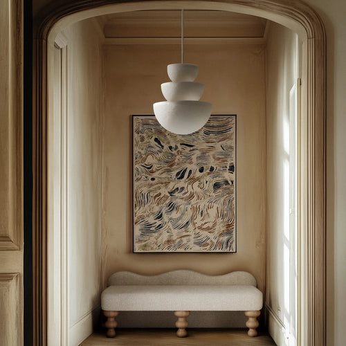 Lemieux et Cie vintage Paris map in black, white and primary colors, framed artwork hung in arched alcove above upholstered bench, warm plaster walls.