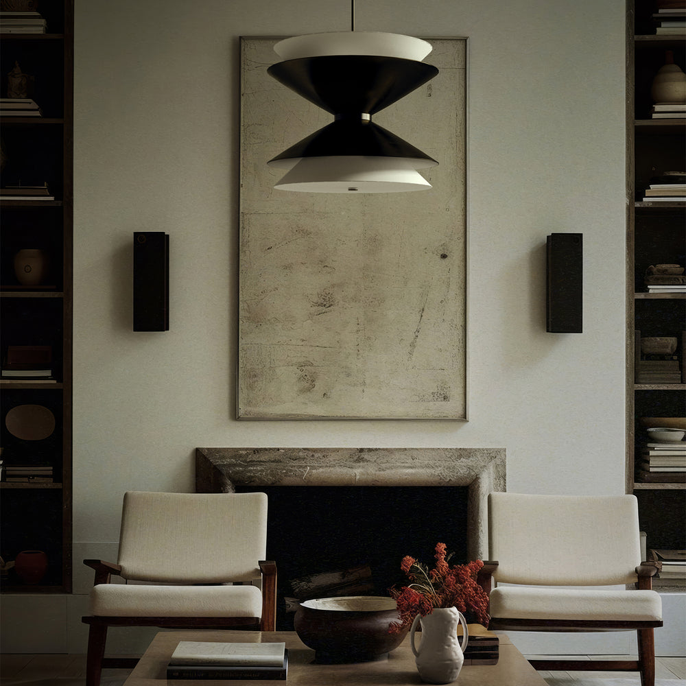 Lemieux et Cie Chambord Extra Large Pendant, a sculptural lighting fixture with layered white shades above wood-framed lounge chairs, a stone fireplace, and white Aquitaine vases on the table.