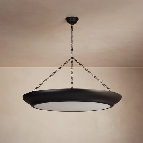 Lemieux et Cie Lenoir Chandelier in matte dark finish, sculptural iron bowl-form pendant suspended by chain, hung in a room with warm plaster walls