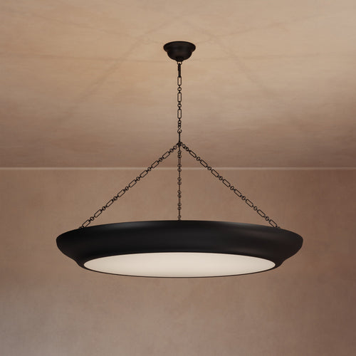 Lemieux et Cie Lenoir Chandelier in matte dark finish, sculptural iron bowl-form pendant suspended by chain against warm plaster ceiling and walls.