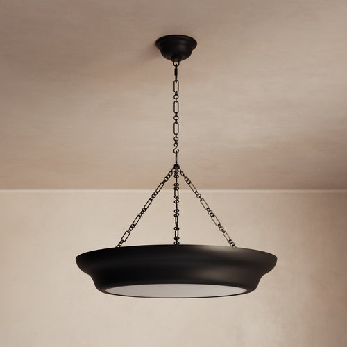 Lemieux et Cie Lenoir Chandelier, sculptural bowl form in dark matte finish suspended by chain, hung against neutral plaster ceiling and walls in soft light.
