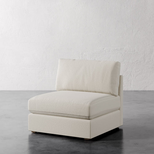 Lemieux Et Cie Chanaux Armless Chair
Beige armchair on a gray floor with a white textured wall background