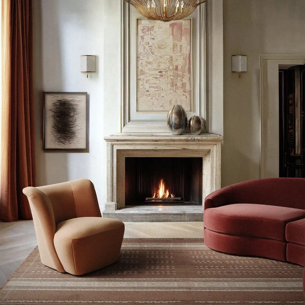 Lemieux et Cie Beaunay Sconces in hand-applied plaster with round bowl shades, flanking a stone fireplace in a sitting room with neutral walls and warm light.