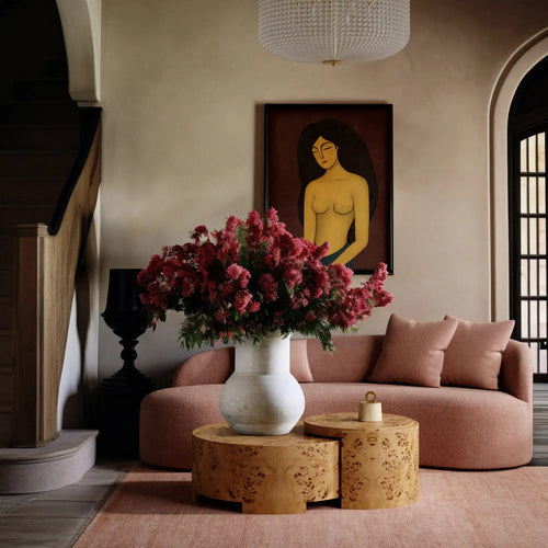 Lemieux et Cie Rondel Bunching Cocktail Table in mappa burl, paired drum forms in a sitting room with blush sofa and neutral plaster walls.