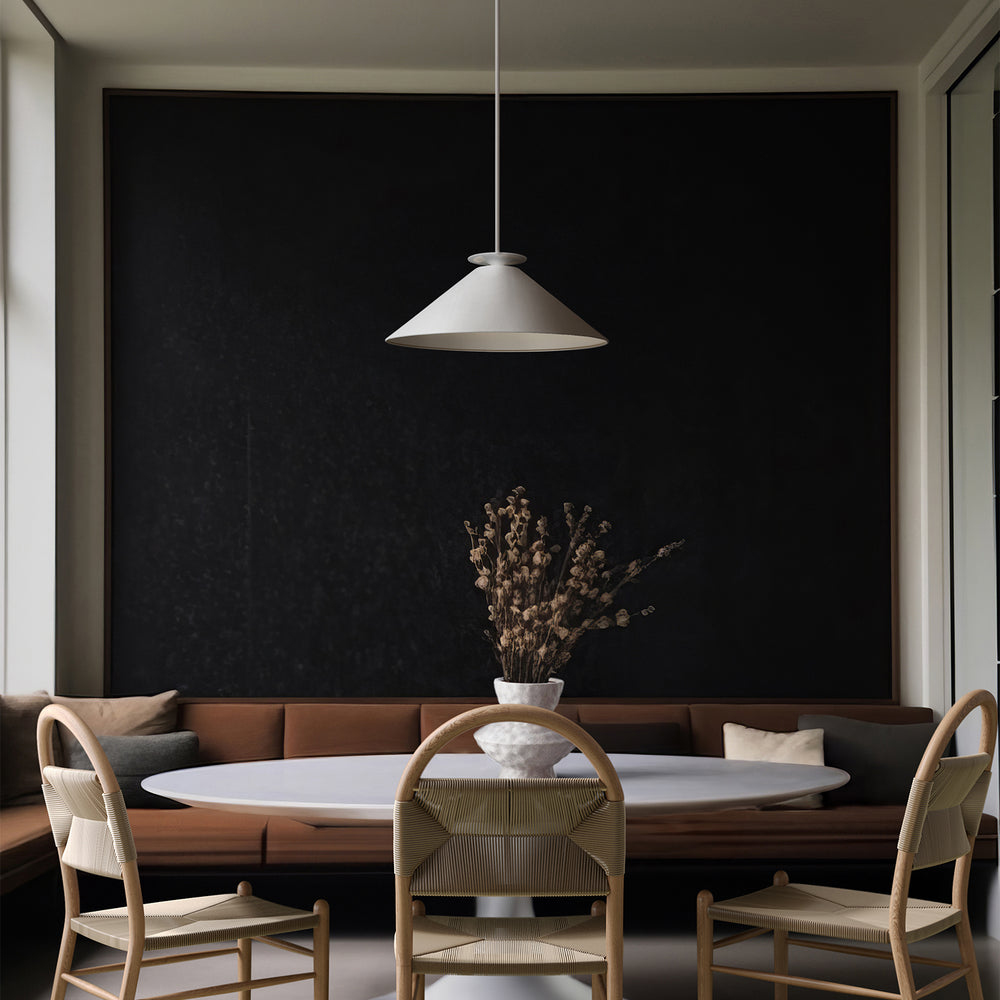 Lemieux et Cie Pontoise Rug in neutral jute, hand-woven flat-weave with embroidered detail, styled in dining room with dark accent wall and warm daylight.