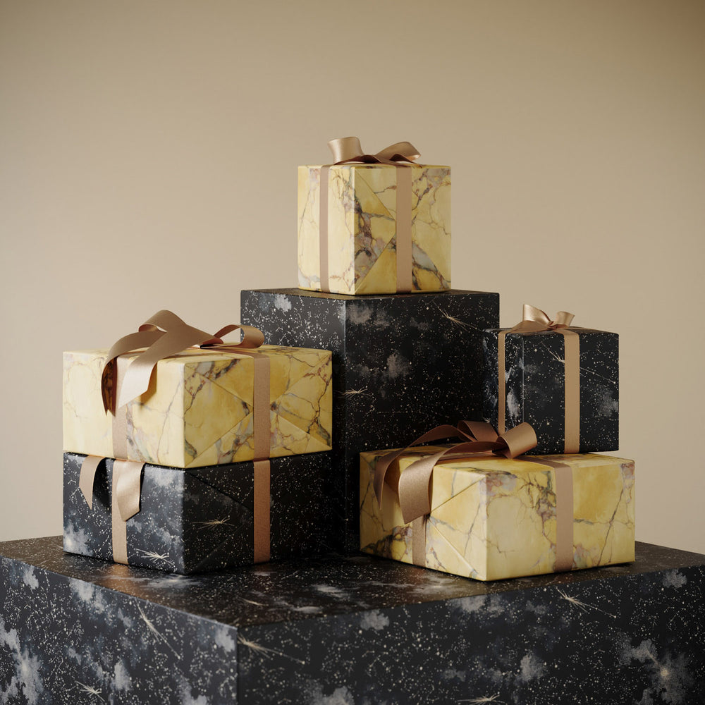Lemieux et Cie Christmas wrapping paper featuring Italian marble in gold and rose paired with Cosmos designer wrapping paper with constellation night sky.