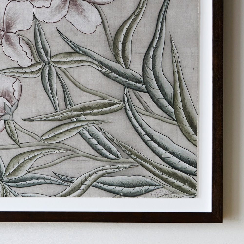 Lemieux et Cie framed botanical print with sage green foliage and blush florals, float mounted on white backer in dark wood frame against white wall.