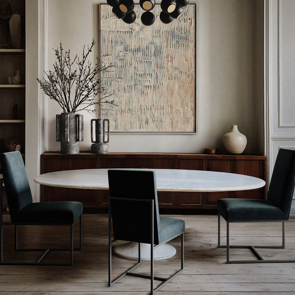 Lemieux et Cie Dupont Dining Side Chair with upholstered seat and backrest on slender metal base, shown in dining room with marble-top table, wood sideboard, and neutral walls.