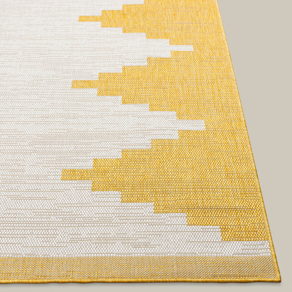 Lemieux et Cie Cottier Outdoor Rug in yellow and ivory, geometric stepped pattern, flat-weave rug shown on neutral studio backdrop.