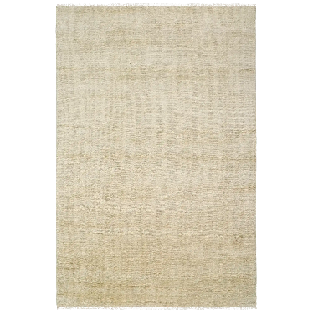 Lemieux et Cie Rochefort rug in cream, hand-knotted wool and cotton with fringe detail, shown on white studio backdrop.