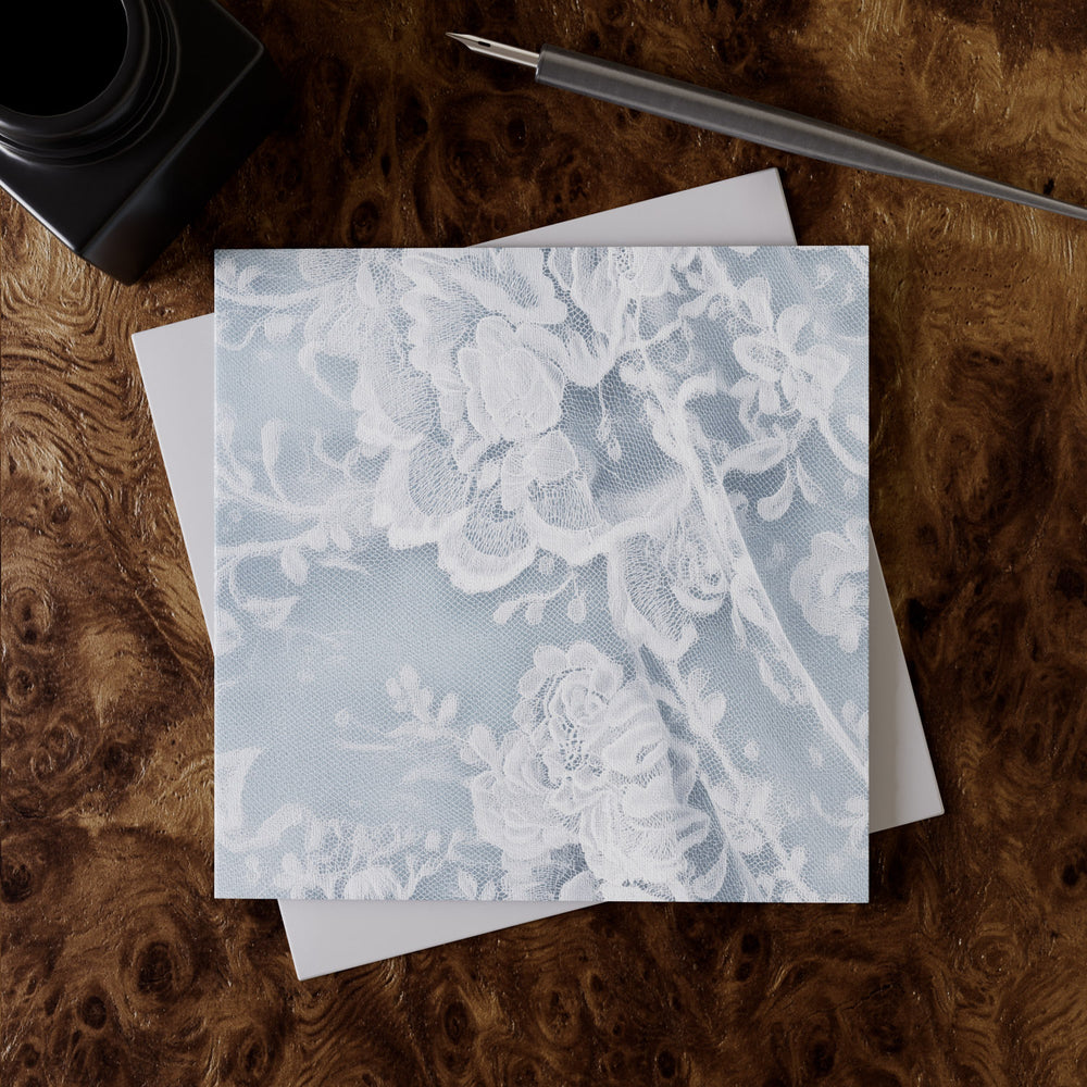Lemieux et Cie French Lace Greeting Card Set in soft blue linen paper, stationery with floral Alençon lace motif, styled on figured wood surface.