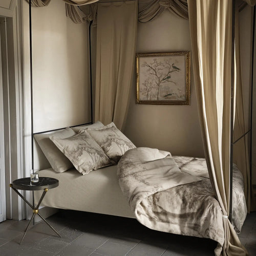 Lemieux et Cie Provençal Scenic Landscape percale duvet cover, shown on canopy bed in neutral bedroom with Cambert iron side table