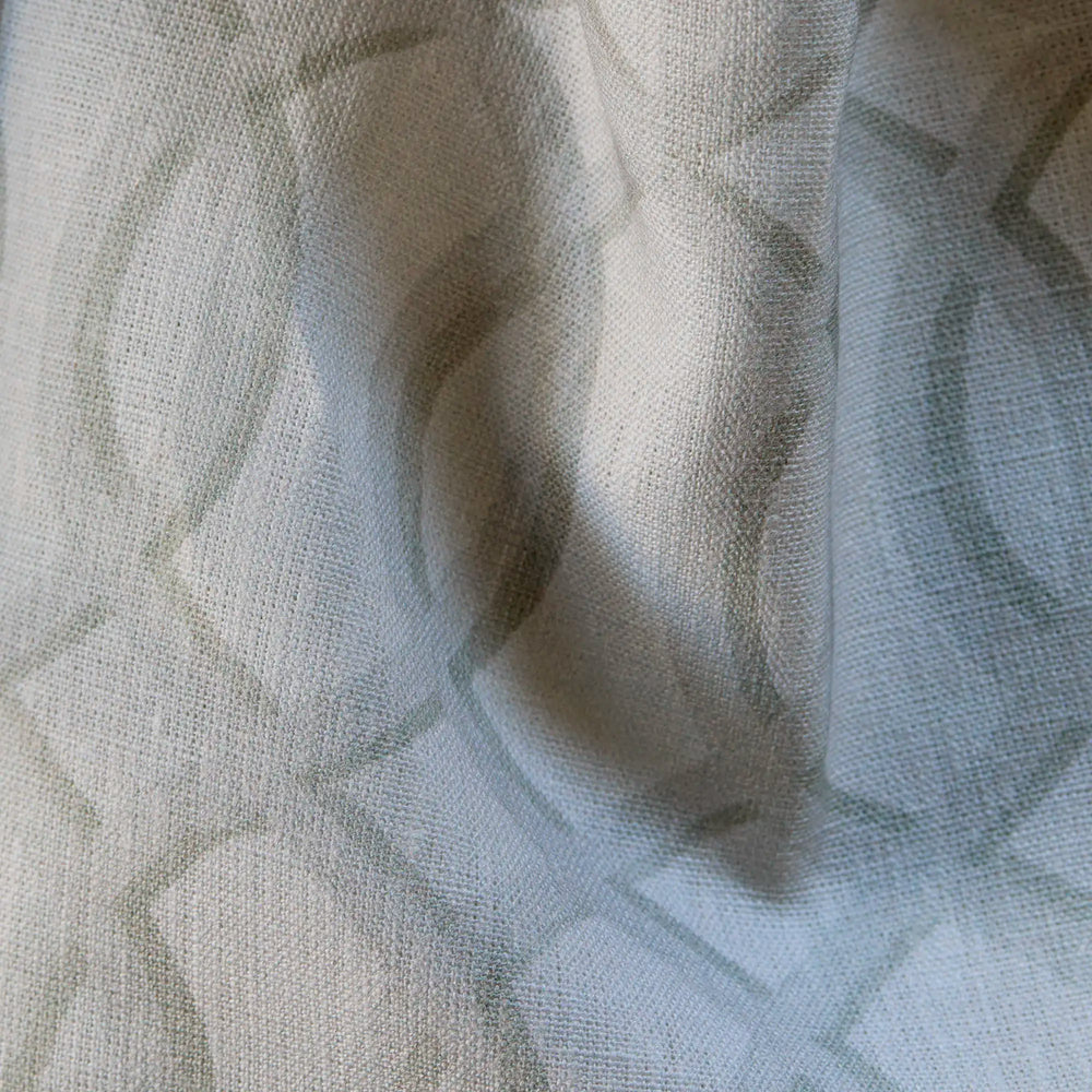 close up of Linen luxury fabric with ecru-on-white architectural lattice pattern on linen with natural slub texture