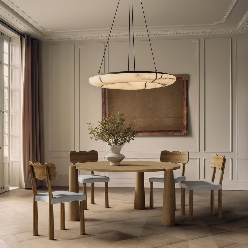 Lemieux et Cie Oak dining chair in walnut finish with bow-shaped back and upholstered seat, shown in dining room with paneled walls and parquet floors.