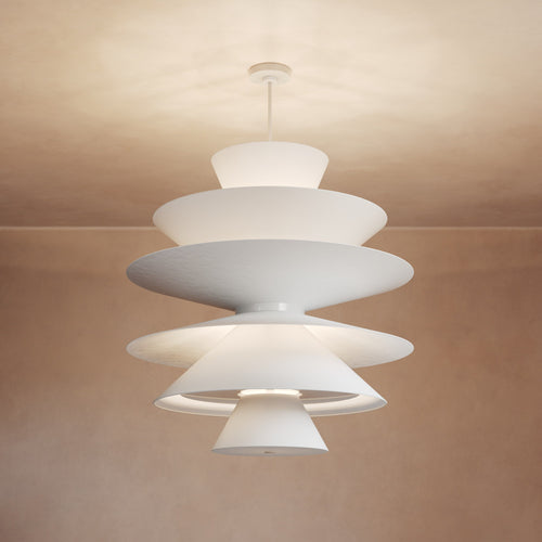 Lemieux et Cie La Brume chandelier, sculptural tiered pendant in white with layered disc shades, ceiling-mounted fixture shown against warm neutral walls.