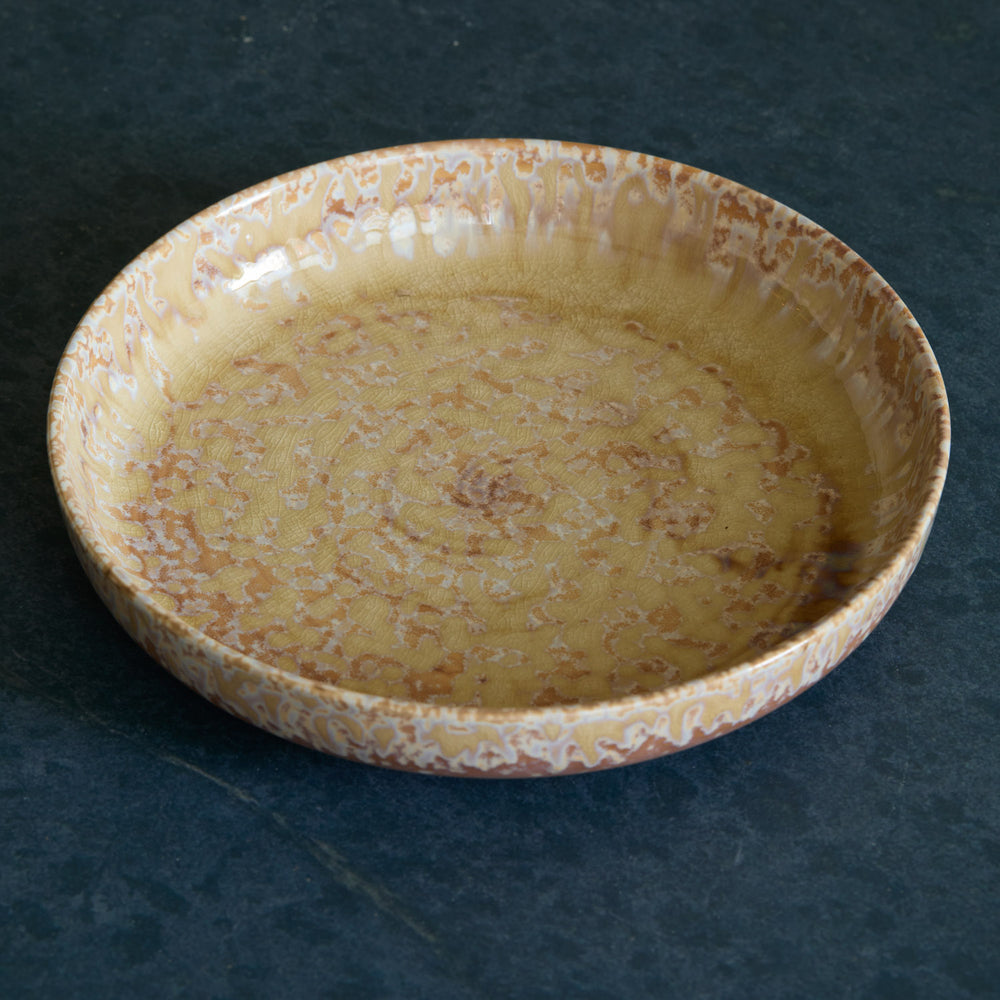 Lemieux et Cie Hanami Pasta Bowl in sand with organic speckled glaze, shallow ceramic bowl shown on dark stone surface.
