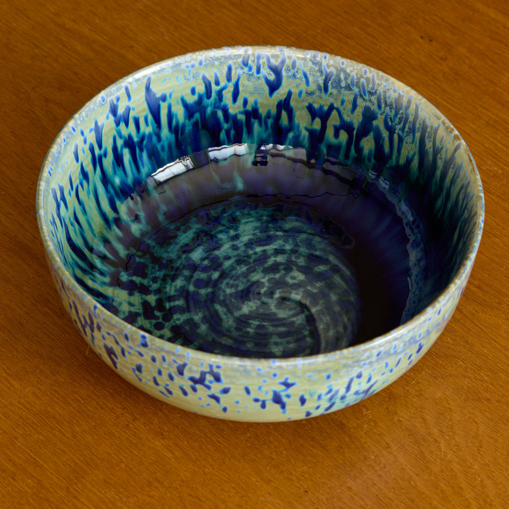 Lemieux et Cie Hanami Stoneware Serving Bowl in indigo with reactive glaze, ceramic bowl with tonal blue-green finish on warm wood surface.