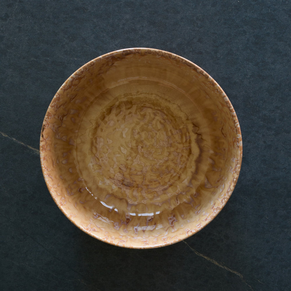Lemieux et Cie Hanami Stoneware Serving Bowl in sand reactive glaze, ceramic bowl with organic tonal variation, shown on dark stone surface.
