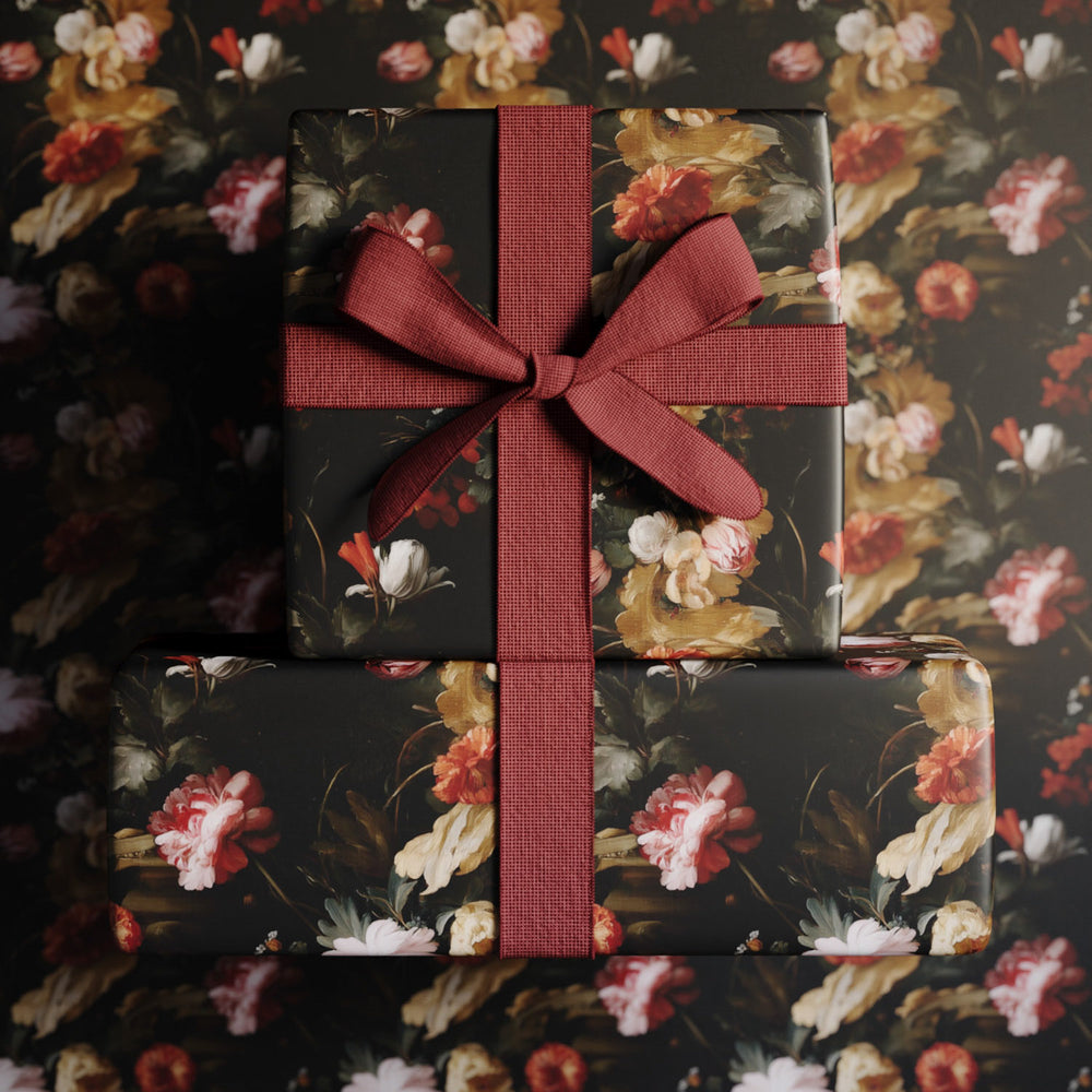 Lemieux et Cie Floral Gift Wrapping Paper with dark botanical blooms in coral, cream and gold, wrapped gift with rust ribbon bow.