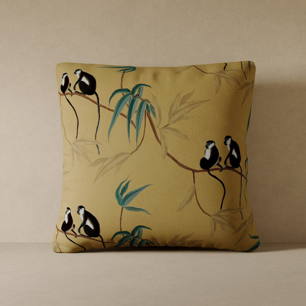 Lemieux et Cie Les Singes Velvet Pillow in gold with black and white monkeys and teal bamboo motif, square pillow shown on neutral surface
