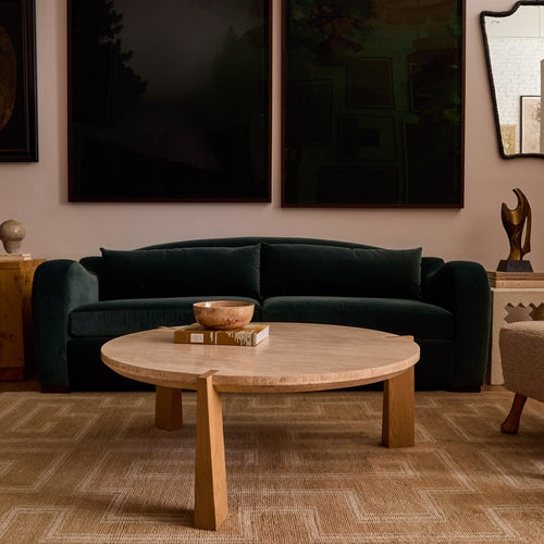 Living room with a dark green sofa and wooden coffee table. indigo_Elodie Sofa