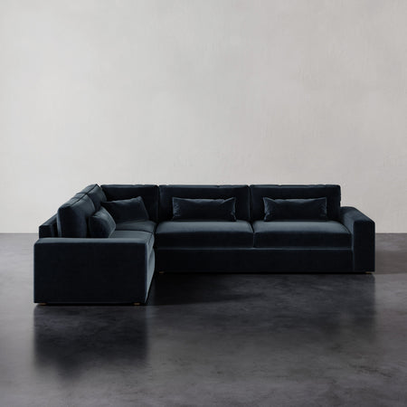 Lemieux et Cie Lacroix Right Arm Sectional, L-shaped modular sofa with bolster pillows, shown on dark concrete floor against neutral walls.
