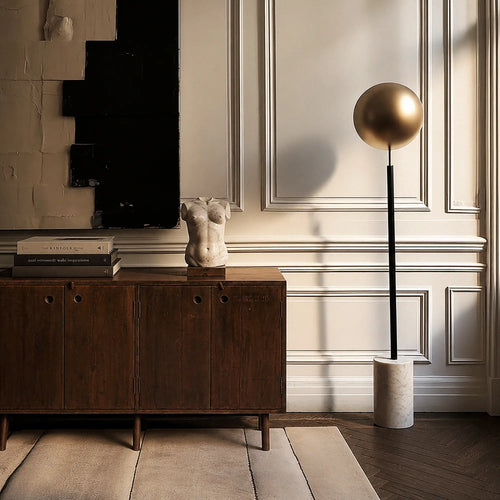 Lemieux et Cie Pierre Jeanneret four-door teak cabinet from Chandigarh, styled beneath textured art, a marble sculpture and books