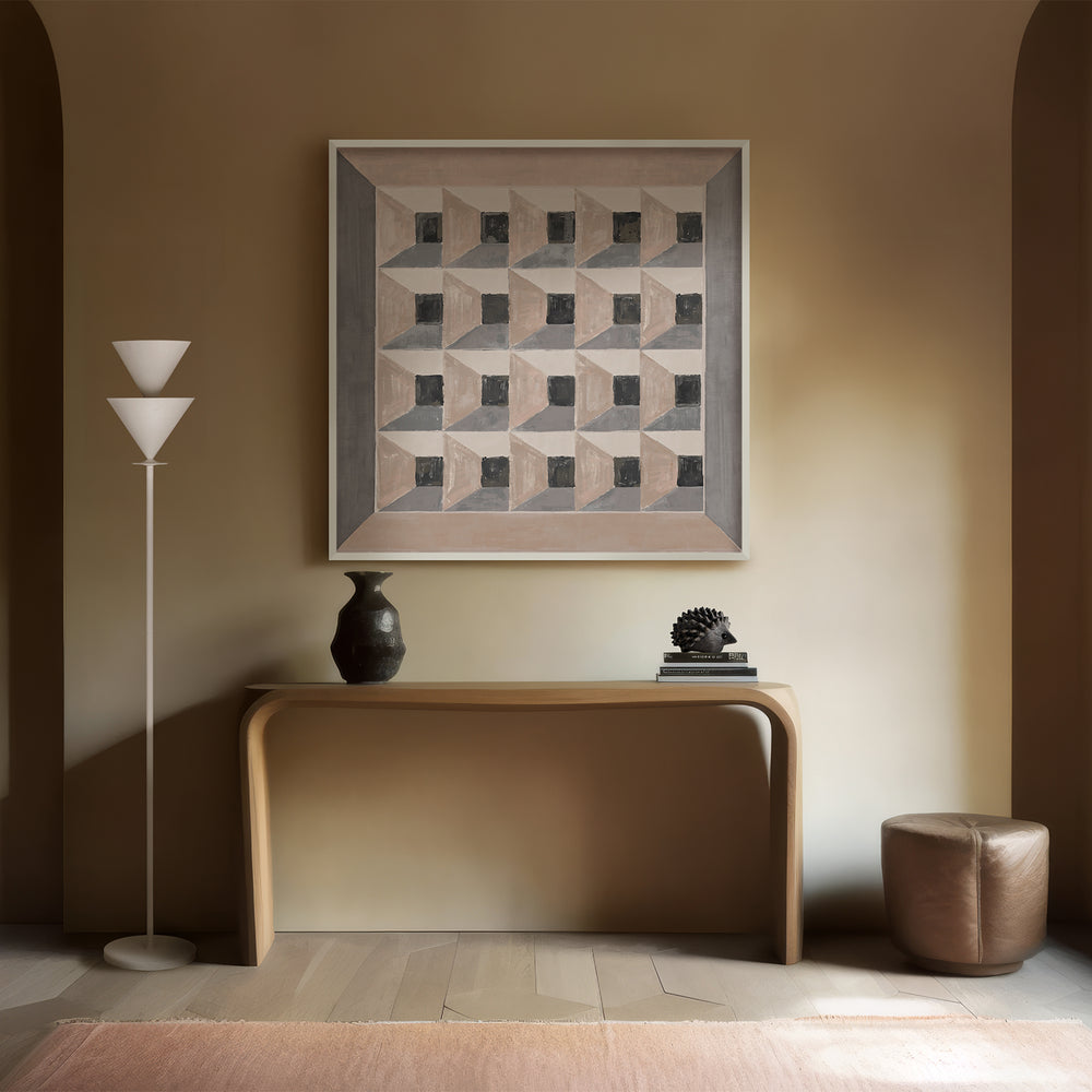 Lemieux et Cie Les Cubes 2 geometric fine art print with trompe-l'oeil effect, displayed above a curved console with dark vase and leather ottoman on light wood floors.