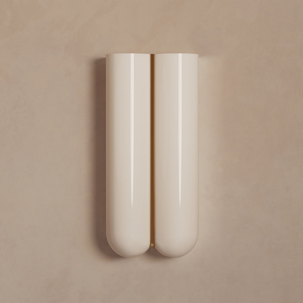 Lemieux et Cie Cheverny Sconce in ivory with brass accent, wall-mounted fixture with sculptural rounded form against a neutral plaster wall.