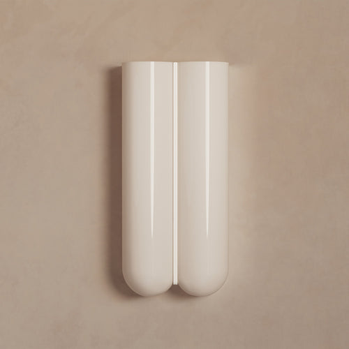 Lemieux et Cie Cheverny sconce in ivory with rounded dual-cylinder form and central slot detail, shown on neutral plaster wall