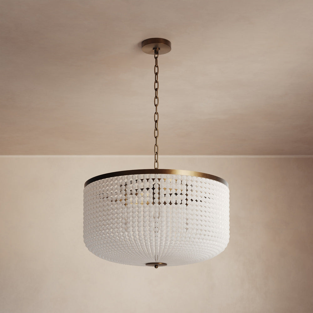 Lemieux et Cie Bellecour Chandelier with hand-strung honed crystal beads and vintage gilded brass frame, suspended from neutral ceiling in warm interior light.