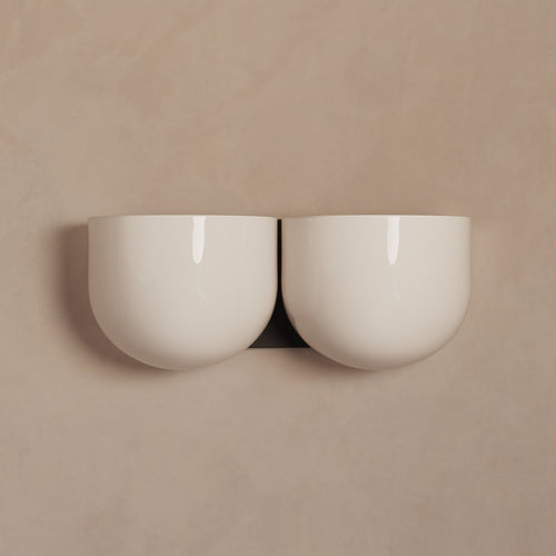 Lemieux et Cie Cheverny Sconce, sculptural double-bowl wall light in ivory, shown against neutral plaster wall in soft light.