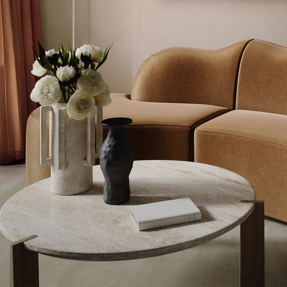 Lemieux et Cie Normandie Vase in natural finish, sculptural vase with square handles, styled on stone coffee table beside camel sofa in warm-lit sitting room.