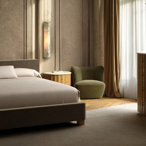 Lemieux et Cie Heavy Linen Coverlet in Soft White, bedding styled in a bedroom with textured plaster walls, warm curtains, and wood flooring.