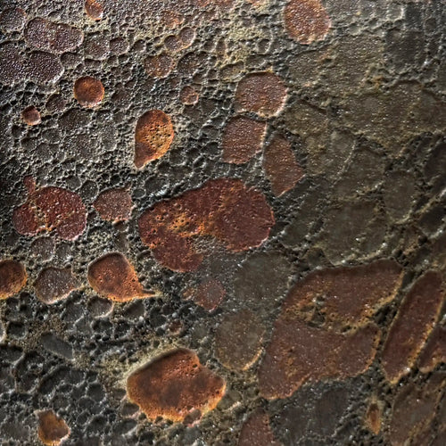 Close-up of a textured glaze surface on the Taiko Stool / End Table by Lemieux et Cie in Oxide Bloom reactive glaze with rust, charcoal, and mineral tones. 